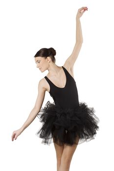 graceful ballerina in black tutu taking a classical dancing pose looking down