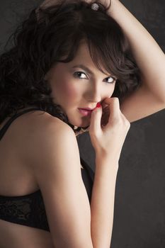 close up portrait of a brunette with make up looking scared in camera