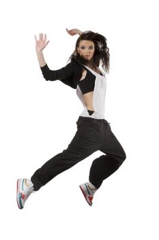 modern young woman dancer in hip hop style jumping over white background looking in camera
