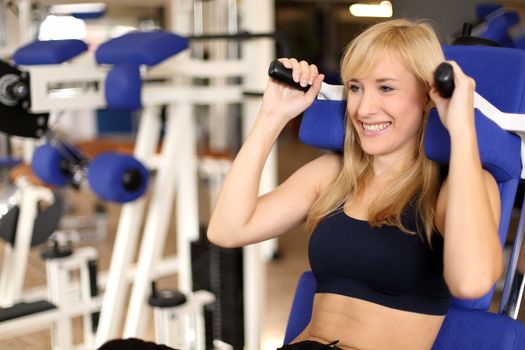 Beautiful young woman working out in a fitness center