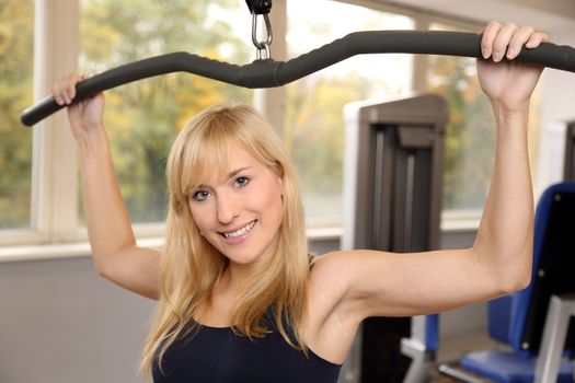 Beautiful young woman working out in a fitness center