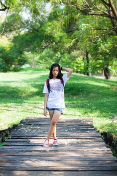 Teenage girl standing. On the road in the park.