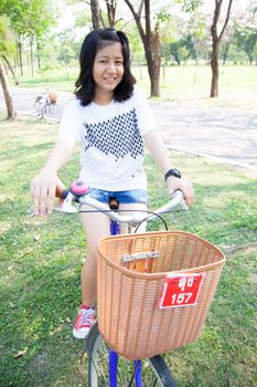 Young woman bicycling. Within the park. The space allocated for bicycling in particular.