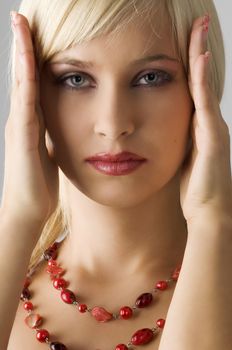 cute blond girl with glamor make up with red necklace