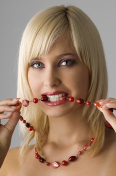cute blond girl with glamor make up with red necklace