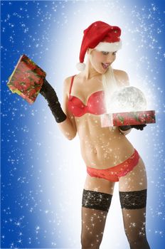 sexy blond in red lingerie looking surprised at christmas present box