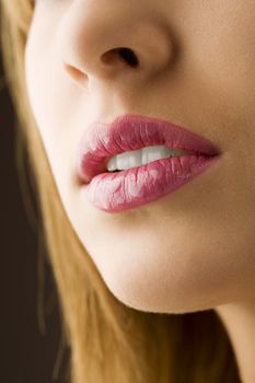 close up on a woman mouth pink colored and wet lips