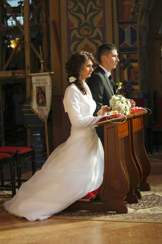 Bride and Groom in the church during wedding ceremony