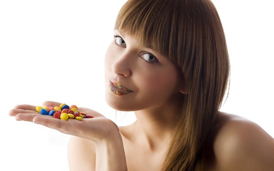 nice portrait of cute model looking in camera with some smarties and multicolor lips