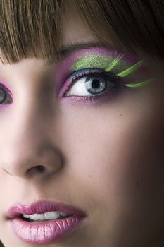 close up on face of beautiful girl with green long eyelashes