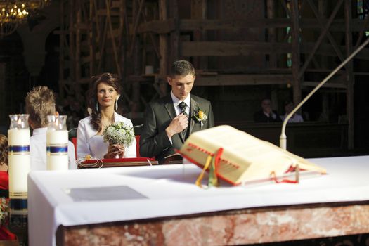 Bride and Groom in the church during wedding ceremony