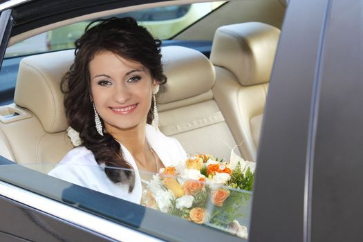 Bride in the car is waiting for the groom