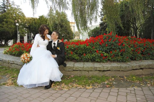 Bride and Groom in the park with the bridal bouquet