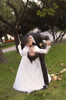 Bride and Groom in the park with the bridal bouquet