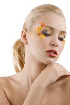 pretty and young blond woman with colored creative make up on white background looking down