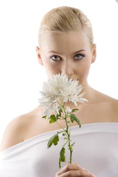 beauty portrait of young cute blond girl with white top and some flowers near face . wellness concept