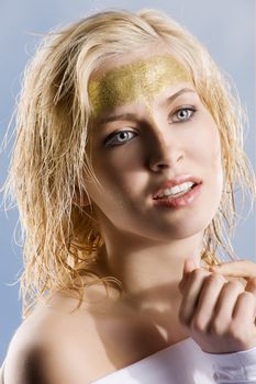 very cute blond girl with wet hair and a creative golden and shining make up