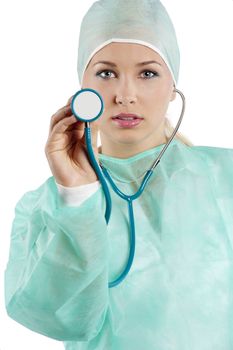 young beauty nurse in green operation dress with stethoscope looking in camera