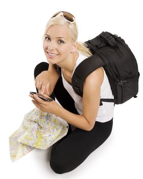 blond girl tourist with map sitting down and using a gps to find the right way