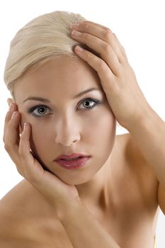 beauty close up portrait of a young blond girl keeping her face between her hands