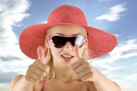 closeup portrait of pretty blond woman wearing a nice summer pink hat and sunglasses
