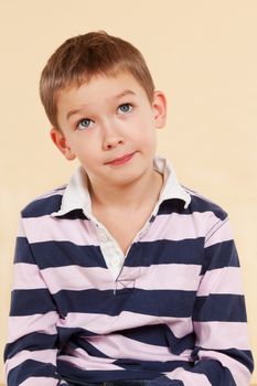 Genius. Young caucasian boy thinking about a project isolated. Facial expressions concept.