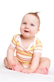 Cute adorable baby girl sitting, smiling and looking. Baby girl sitting isolated on white background. Happy family concept.