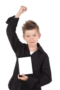 Successful boy with hand up holding tablet with white screen facing camera isolated on white background.