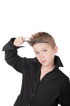 Charming young casual boy with cool haircut, holding hairbrush isolated on white background. Man fashion concept.