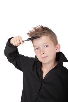 Charming boy with hairbrush and modern cool haircut isolated on white background. 