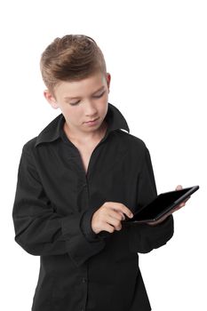 Charming young successful boy using his tablet isolated on white background.