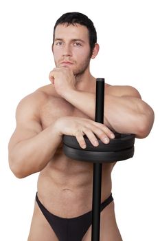 Attractive bodybuilder leaning on barbell, touching chin, looking into camera and thinking isolated on white background. Muscle, Fitness and Bodybuilding.