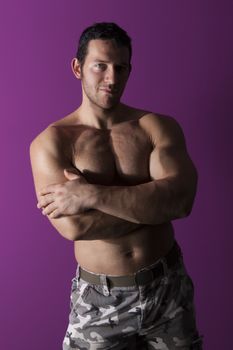 Sexy muscular shirtless bodybuilder smiling and looking into the camera isolated. Fitness is sexy.