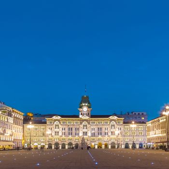 The City Hall, Palazzo del Municipio, is the dominating building on Trieste's main square Piazza dell Unita d Italia. Trieste, Italy, Europe. Illuminated city square shot at dusk.