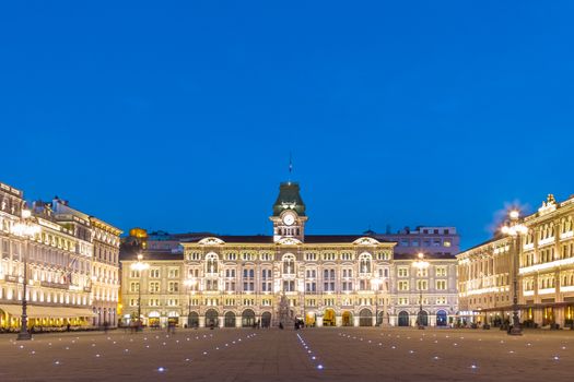 The City Hall, Palazzo del Municipio, is the dominating building on Trieste's main square Piazza dell Unita d Italia. Trieste, Italy, Europe. Illuminated city square shot at dusk.