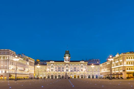 The City Hall, Palazzo del Municipio, is the dominating building on Trieste's main square Piazza dell Unita d Italia. Trieste, Italy, Europe. Illuminated city square shot at dusk.