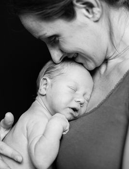 Mother holding tenderly a newborn baby boy, 11 day old