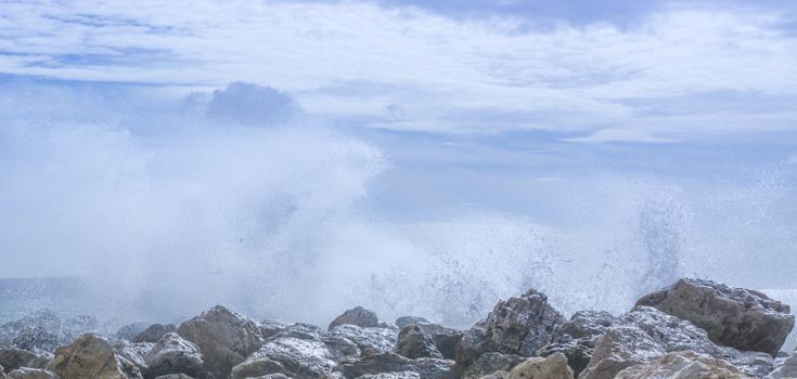 Wave spray rocks. Large waves crashing ashore on rocks by Cala Estancia pier, Cala Estancia, Mallorca, Balearic islands, Spain.