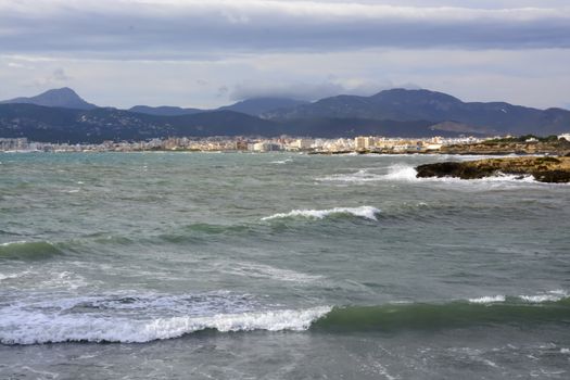 Palma cityline November. Colors are shifting to deeper blues and greens and seas become choppy. Palma bay, Mallorca, Balearic islands, Spain.