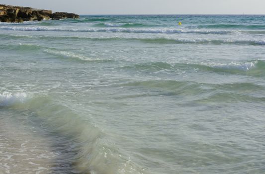 Shallow Waves Azure Water at Ses Covetes, Mallorca, Balearic islands, Spain.