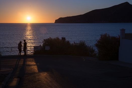 Mediterranean sunset couple. Couple enjoying a romantic sunset. Mallorca, Balearic islands, Spain.