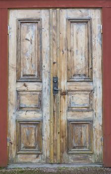 Grungy Wood Door on red house, Varmland, Sweden.