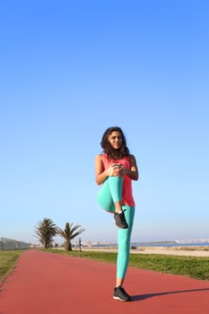 Fit woman preparing to run in the city park