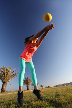 Woman playing with a ball in the city park