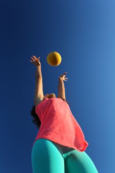 Woman playing with a ball in the city park