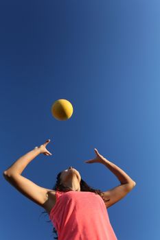 Woman playing with a ball in the city park