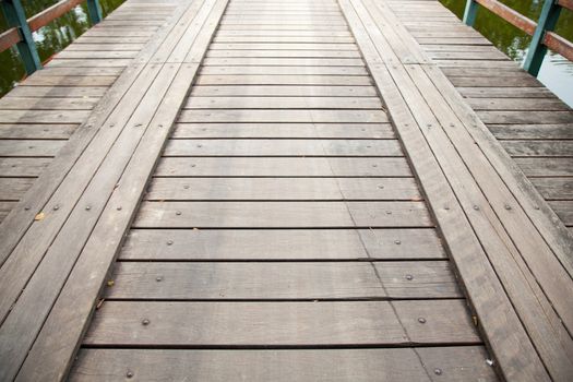 Long wooden bridge ahead. For the car and walk across the pool.