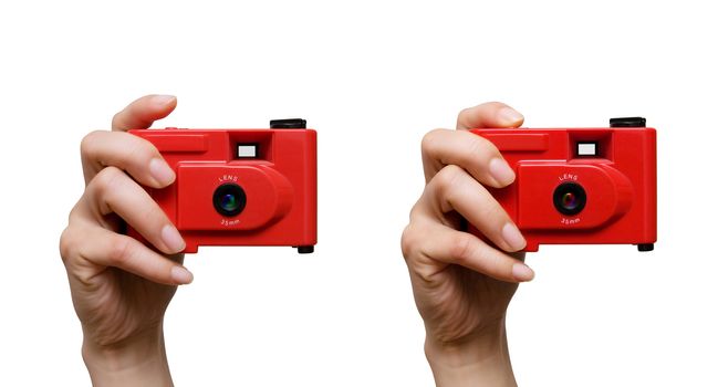 Camera in a hand isolated on white background