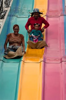 Atlanta, GA, USA - March 15, 2014:  A family goes down the fun slide at the annual Atlanta Fair. 