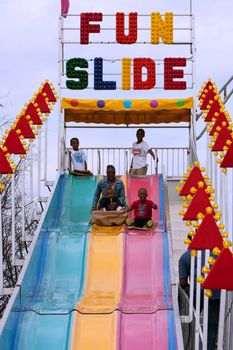 Atlanta, GA, USA - March 15, 2014:  A family slides down the fun slide at the annual Atlanta Fair.